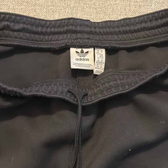 Adidas black joggers with zipper pockets and 3 stripes on bottom of one leg - Picture 4 of 4